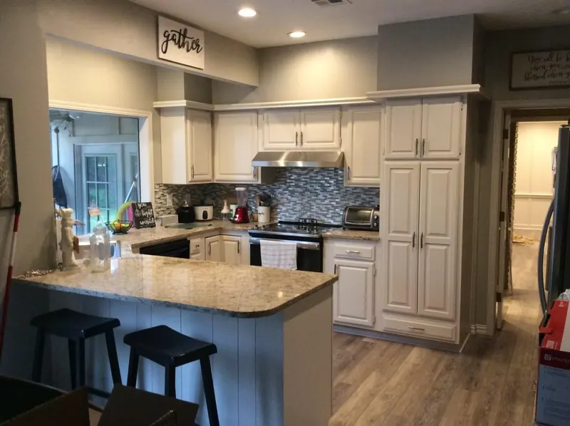 Remodeled kitchen with island and granite countertops